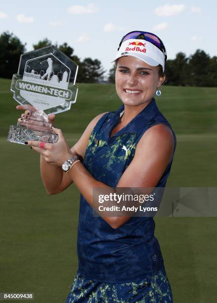 Lexi Thompson celebratesholds the winner's trophy after winning the Indy Women In Tech Championship-Presented By Guggenheim at the Brickyard Crossing...