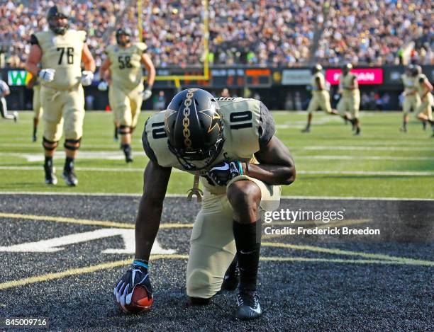 Trent Sherfield of the Vanderbilt Commodores kneels after scoring a touchdown against the Alabama A&M Bulldogs during the first half at Vanderbilt...