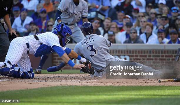 Alex Avila of the Chicago Cubs tags out Orlando Arcia of the Milwaukee Brewers at the plate in the 5th inning at Wrigley Field on September 9, 2017...