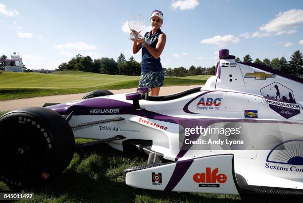 Lexi Thompson poses with a race car after winning the Indy Women In Tech Championship-Presented By Guggenheim at the Brickyard Crossing Golf Course...