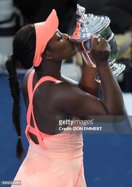 Sloane Stephens of the US kisses her trophy after defeating compatriot Madison Keys in their US Open Women's Singles Final match Septmber 9, 2017 at...