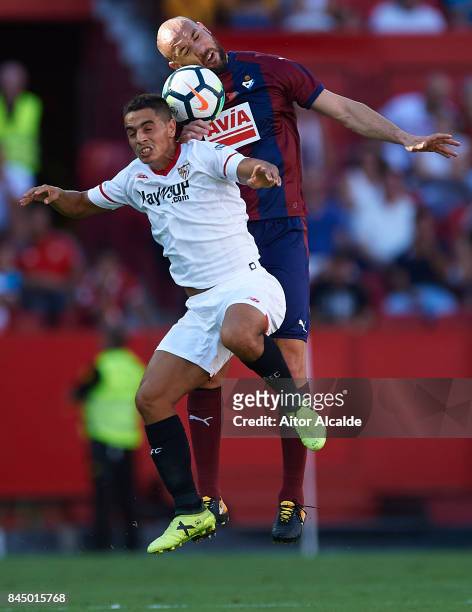 Wissam Ben Yedder of Sevilla FC competes for the ball with Ivan Ramis of SD Eibar during the La Liga match between Sevilla and Eibar at Estadio Ramon...