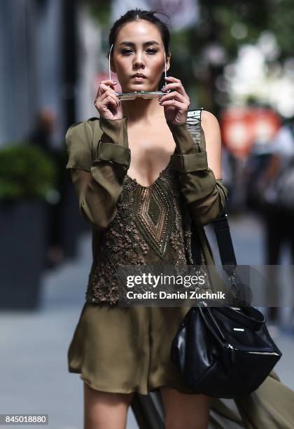 Janie Tienphosuwan is seen wearing a Sally Lapointe dress, Givenchy bag and Gentlemonster sunglasses outside the Rebecca Minkoff show during New York...