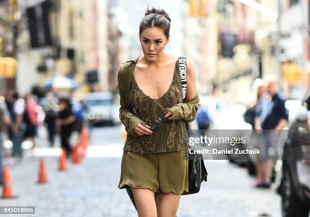 Janie Tienphosuwan is seen wearing a Sally Lapointe dress, Givenchy bag and Gentlemonster sunglasses outside the Rebecca Minkoff show during New York...