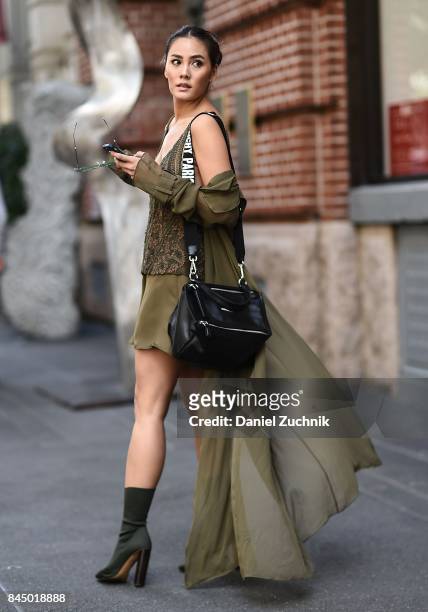 Janie Tienphosuwan is seen wearing a Sally Lapointe dress, Yeezy shoes, Givenchy bag and Gentlemonster sunglasses outside the Rebecca Minkoff show...