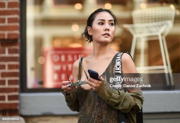 Janie Tienphosuwan is seen wearing a Sally Lapointe dress, Givenchy bag and Gentlemonster sunglasses outside the Rebecca Minkoff show during New York...