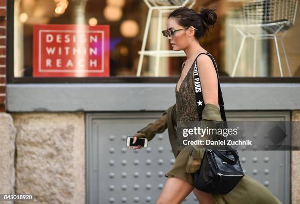 Janie Tienphosuwan is seen wearing a Sally Lapointe dress, Givenchy bag and Gentlemonster sunglasses outside the Rebecca Minkoff show during New York...