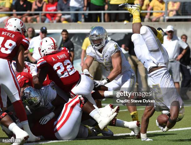 Running back Royce Freeman of the Oregon Ducks gets fliped over as he dives into the end zone for a touchdown during the second quarter of the game...