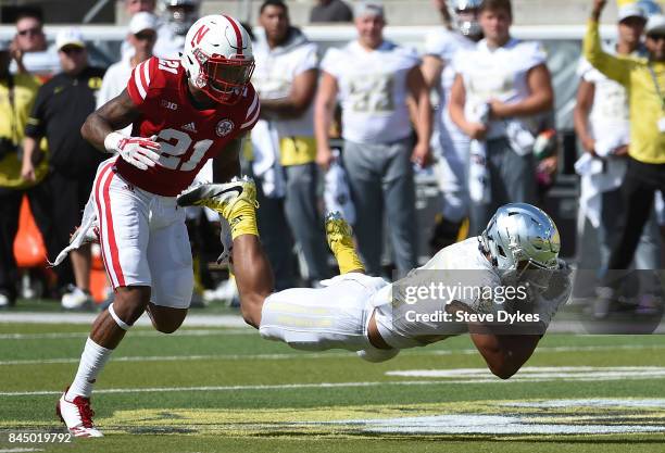 Wide receiver Johnny Johnson III of the Oregon Ducks catches a pass in front of Lamar Jackson of the Nebraska Cornhuskers during the second quarter...