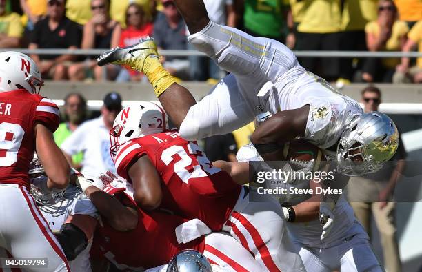 Running back Royce Freeman of the Oregon Ducks gets fliped over as he dives into the end zone for a touchdown during the second quarter of the game...