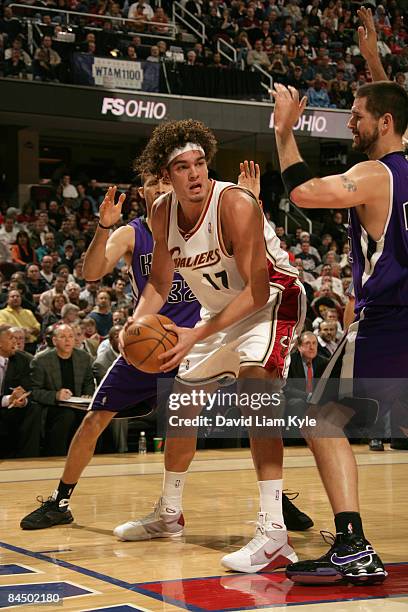 Anderson Varejao of the Cleveland Cavaliers looks for an open teammate defended by Francisco Garcia and Brad Miller of the Sacramento Kings at The...