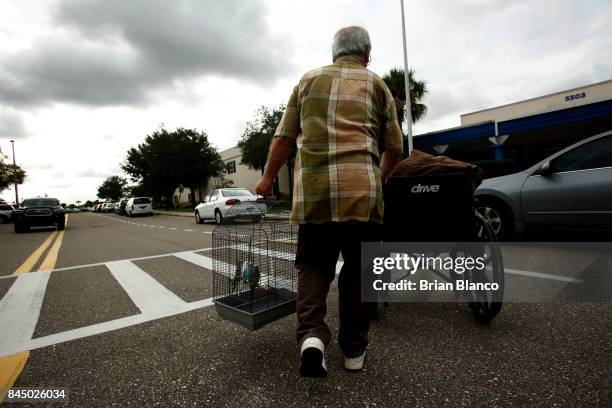 With the sky above him turning grey and the wind picking up, Ed Questell makes his way into an evacuation shelter at McKitrick Elementary School with...