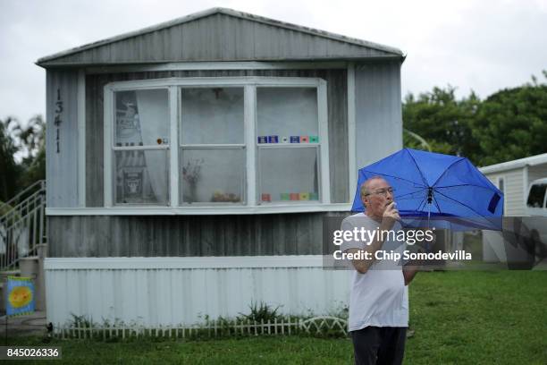 Jeff Weiner steps out of his trailer to smoke and look at the sky in the Sunshine Village mobile home community ahead of the arrival of Hurricane...