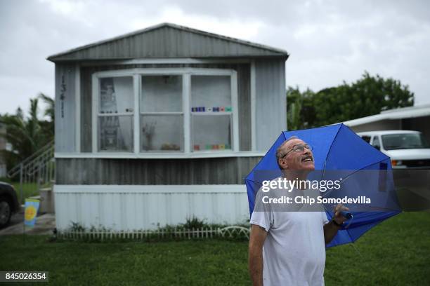 Jeff Weiner steps out of his trailer to smoke and look at the sky in the Sunshine Village mobile home community ahead of the arrival of Hurricane...