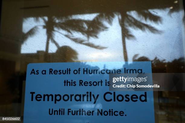 Signs announce the temporary closure of The Ritz-Carlton Hotel at Sebastian Street Beach ahead of the arrival of Hurricane Irma September 9, 2017 in...