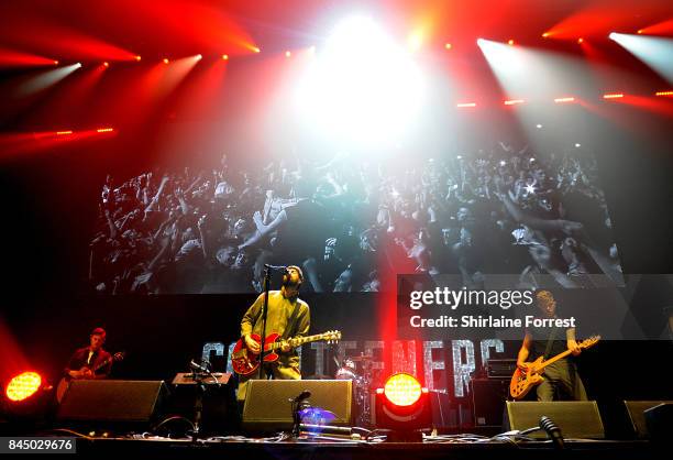 Liam Fray, Daniel 'Conan' Moores and Michael Campbell of Courteeners perform during the 'We Are Manchester' benefit concert at Manchester Arena on...