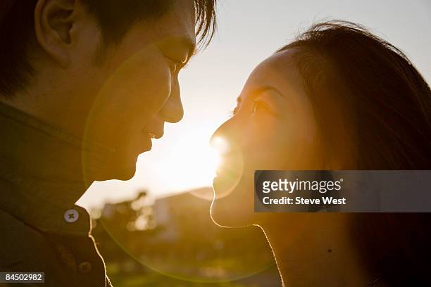 couple looking at each other close up at sunset - west asia stock-fotos und bilder