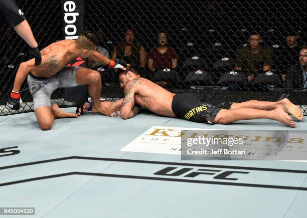 Kajan Johnson of Canada knocks out Adriano Martins of Brazil in their lightweight bout during the UFC 215 event inside the Rogers Place on September...