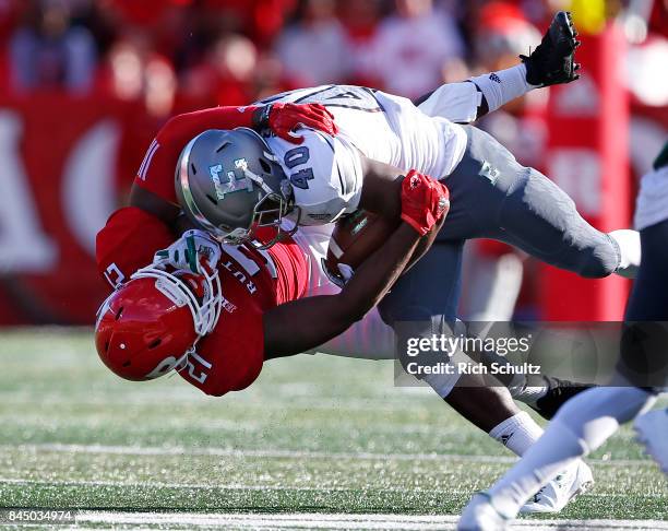 Eddie Daugherty of the Eastern Michigan Eagles is tackled by Ross Douglas of the Rutgers Scarlet Knights during the second quarter of a game on...