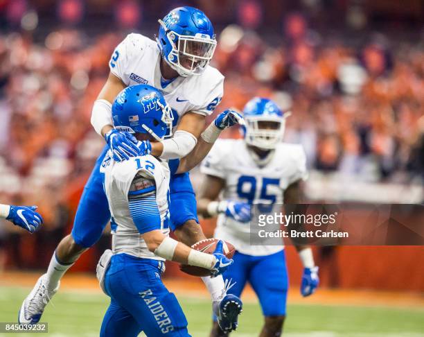 Alex Dale of the Middle Tennessee Blue Raiders congratulates Reed Blankenship for his fourth quarter interception against the Syracuse Orange on...