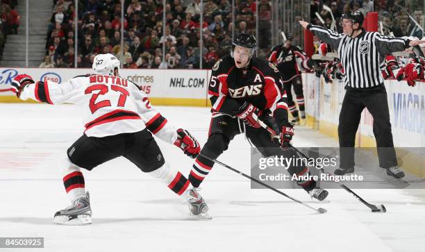 Dany Heatley of the Ottawa Senators stickhandles the puck against Mike Mottau of the New Jersey Devils at Scotiabank Place on January 27, 2009 in...