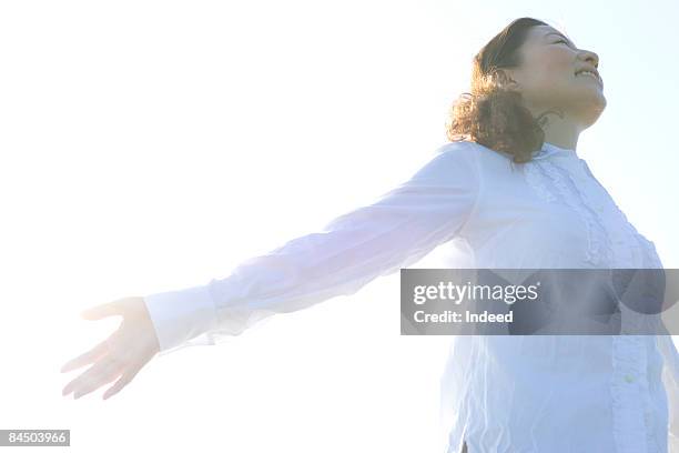 mature woman stretching arms, smiling - 解放 ストックフォトと画像