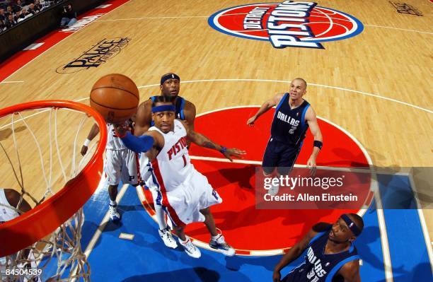 Allen Iverson of the Detroit Pistons shoots a layup against Erick Dampier and Jason Terry of the Dallas Mavericks during the game at the Palace of...