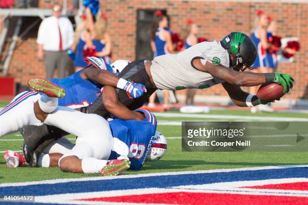 Jeffery Wilson of the North Texas Mean Green dives into the end zone for a touchdown against the SMU Mustangs during the first half at Gerald J. Ford...