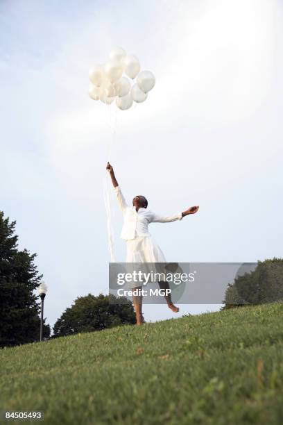 mature african american woman with balloons - black balloons foto e immagini stock