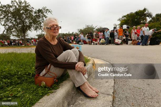 Barbara Sabol, age 70, of Cape Coral, waits to get into a shelter in Estero, Florida. She is from Cape Coral, where she had to leave her cat. She was...