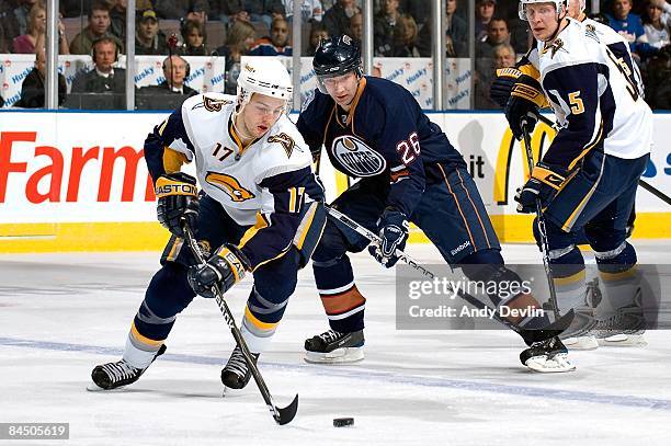 Marc-Andre Gragnani of the Buffalo Sabres carries the puck while being chased by Erik Cole of the Edmonton Oilers at Rexall Place on January 27, 2009...