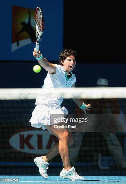 Carla Suarez Navarro of Spain plays a backhand in her quarterfinal match against Elena Dementieva of Russia during day ten of the 2009 Australian...
