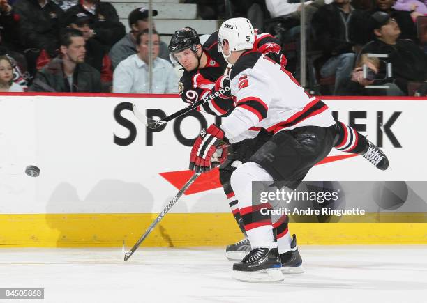 Jason Spezza of the Ottawa Senators shoots the puck past Colin White of the New Jersey Devils at Scotiabank Place on January 27, 2009 in Ottawa,...