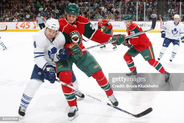 Derek Boogaard of the Minnesota Wild checks Jonas Frogren of the Toronto Maple Leafs during the game at the Xcel Energy Center on January 27, 2009 in...