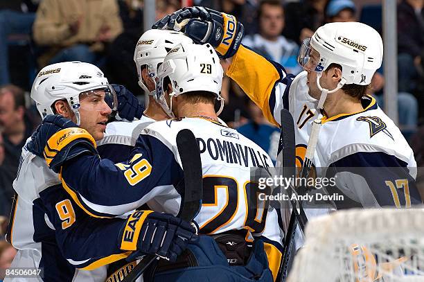 Derek Roy, Tim Connolly and Marc-Andre Gragnani of the Buffalo Sabres celebrate a second period goal against the Edmonton Oilers at Rexall Place on...