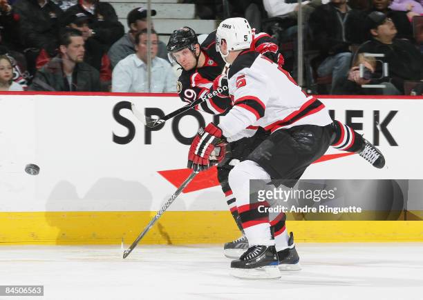 Jason Spezza of the Ottawa Senators shoots the puck past Colin White of the New Jersey Devils at Scotiabank Place on January 27, 2009 in Ottawa,...