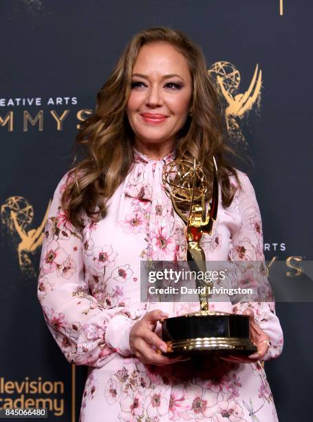 Actress Leah Remini poses in the press room with the award for outstanding informational series or special for "Leah Remini: Scientology and the...