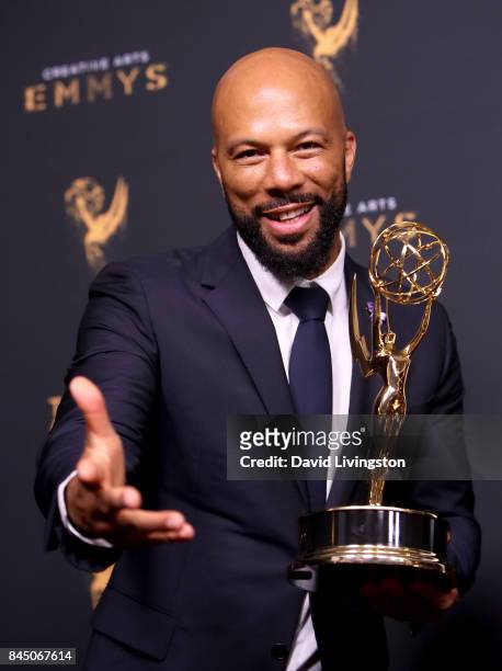 Hip-hop artist Common poses in the press room with the award for outstanding original music and lyrics for "13th Song Title: Letter to the Free"...