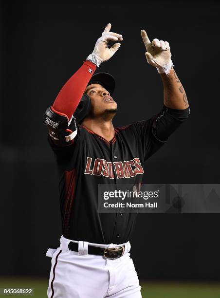 Ketel Marte of the Arizona Diamondbacks gestures to the sky after hitting a single during the fifth inning against the San Diego Padres at Chase...