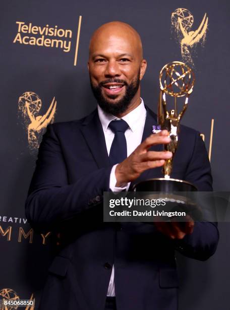 Hip-hop artist Common poses in the press room with the award for outstanding original music and lyrics for "13th Song Title: Letter to the Free"...