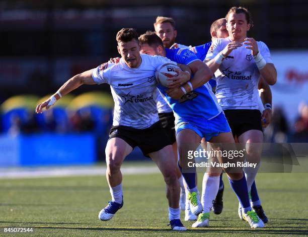 Blake Wallace of Toronto Wolfpack breaks the tackle of Lewis Charnock of Barrow Raiders during a Kingstone Press League 1 Super 8s match at Lamport...