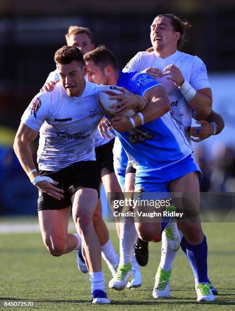 Blake Wallace of Toronto Wolfpack breaks the tackle of Lewis Charnock of Barrow Raiders during a Kingstone Press League 1 Super 8s match at Lamport...