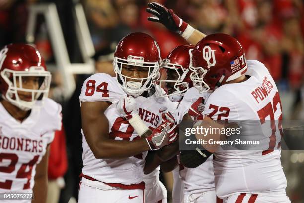 Lee Morris of the Oklahoma Sooners celebrates with teammates after scoring a touchdown on an 18-yard reception during the third quarter against the...