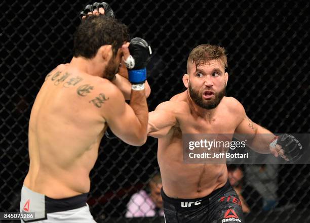 Jeremy Stephens punches Gilbert Melendez in their featherweight bout during the UFC 215 event inside the Rogers Place on September 9, 2017 in...