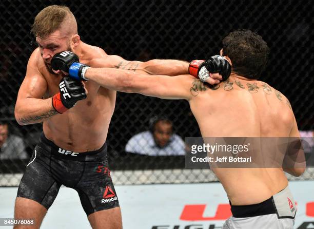 Gilbert Melendez punches Jeremy Stephens in their featherweight bout during the UFC 215 event inside the Rogers Place on September 9, 2017 in...