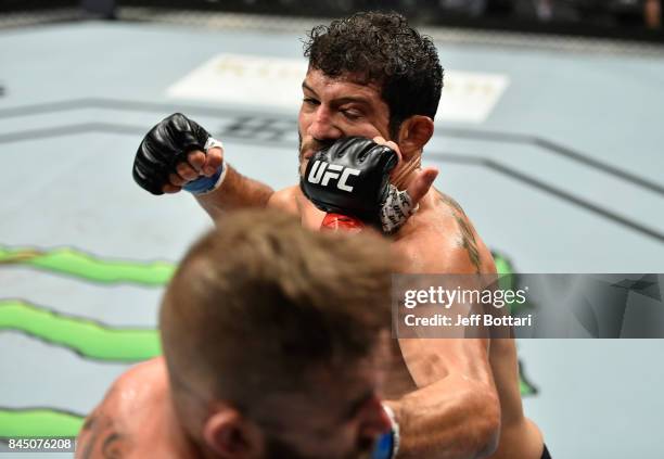 Jeremy Stephens punches Gilbert Melendez in their featherweight bout during the UFC 215 event inside the Rogers Place on September 9, 2017 in...