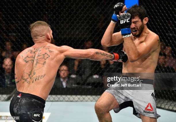 Jeremy Stephens punches Gilbert Melendez in their featherweight bout during the UFC 215 event inside the Rogers Place on September 9, 2017 in...