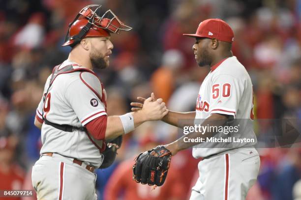 Cameron Rupp of the Philadelphia Phillies and Hector Neris celebrate a win after a baseball game at Nationals Park on September 9, 2017 in...