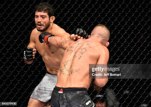 Jeremy Stephens punches Gilbert Melendez in their featherweight bout during the UFC 215 event inside the Rogers Place on September 9, 2017 in...
