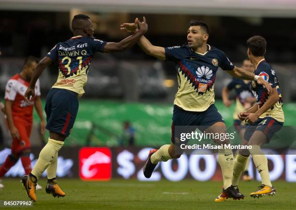 Silvio Romero of America celebrates with teammate Darwin Quintero after scoring his team's first goal during the eighth round match between America...